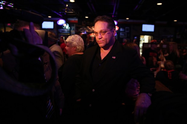 Former Bears player and Romeoville mayoral candidate Steve McMichael waits to give a TV interview moments after giving a concession speech after losing to incumbent John Noak on April 9, 2013. (Anthony Souffle/Chicago Tribune)
