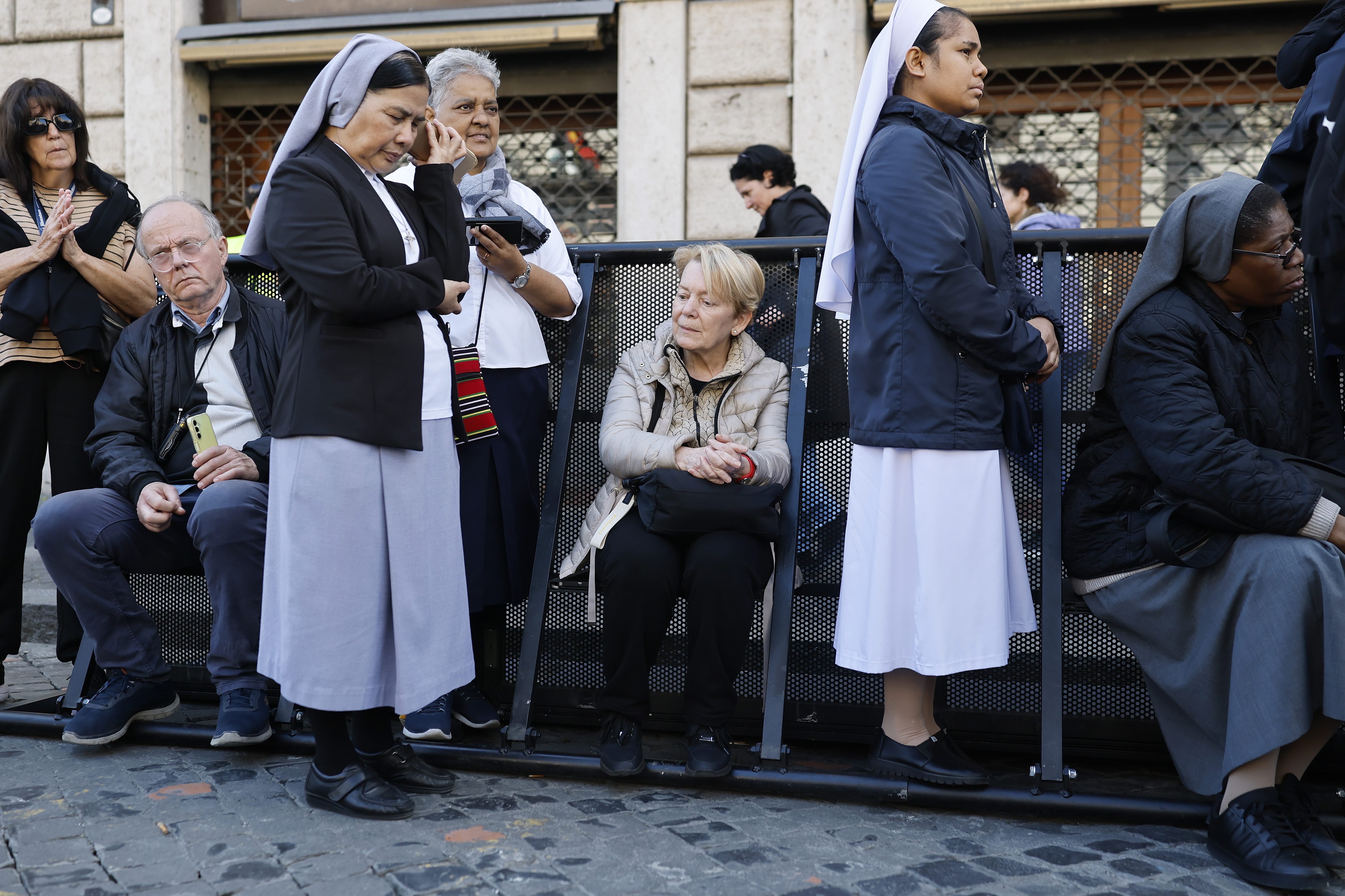 Nuns and faithfuls gather during the funeral of Pope Francis in Via della Conciliazione on April 26, 2025 in Rome, Italy. Pope Francis died on April 21st at the age of 88. Born in Argentina as Jorge Mario Bergoglio, he was the first Latin American and the first Jesuit to become Pope when elected in 2013. Taking the name Francis after St Francis of Assisi, he promoted a more humble version of the papacy than many of his predecessors. He will be buried outside of the Vatican in a simple wooden coffin at the Basilica Santa Maria Maggiore. (Photo by Mario Tama/Getty Images)