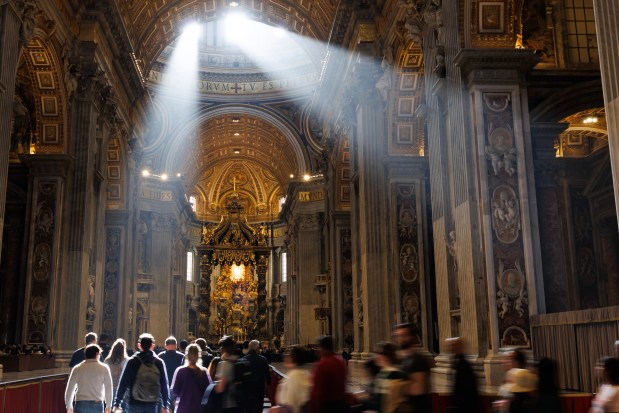 Light pours into St Peters Basilica as the queue files past the late Pope Francis on April 25, 2025 in Vatican City, Vatican. Pope Francis, who died on April 21, is lying in state for the final day ahead of Saturday's funeral in St. Peter's Square. (Dan Kitwood/Getty)