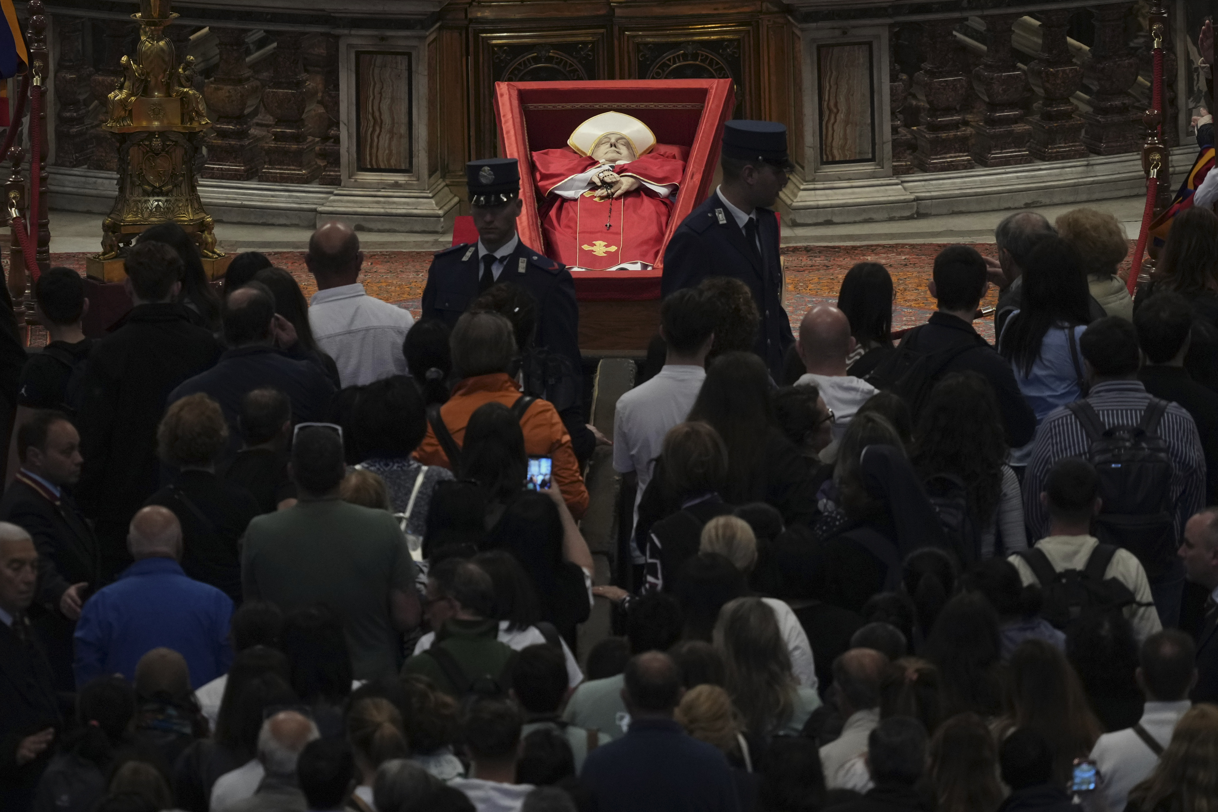 People line up to pay their respects to Pope Francis lying in state, inside St. Peter's Basilica, at the Vatican, Friday, April 25, 2025. (AP Photo/Andrew Medichini)