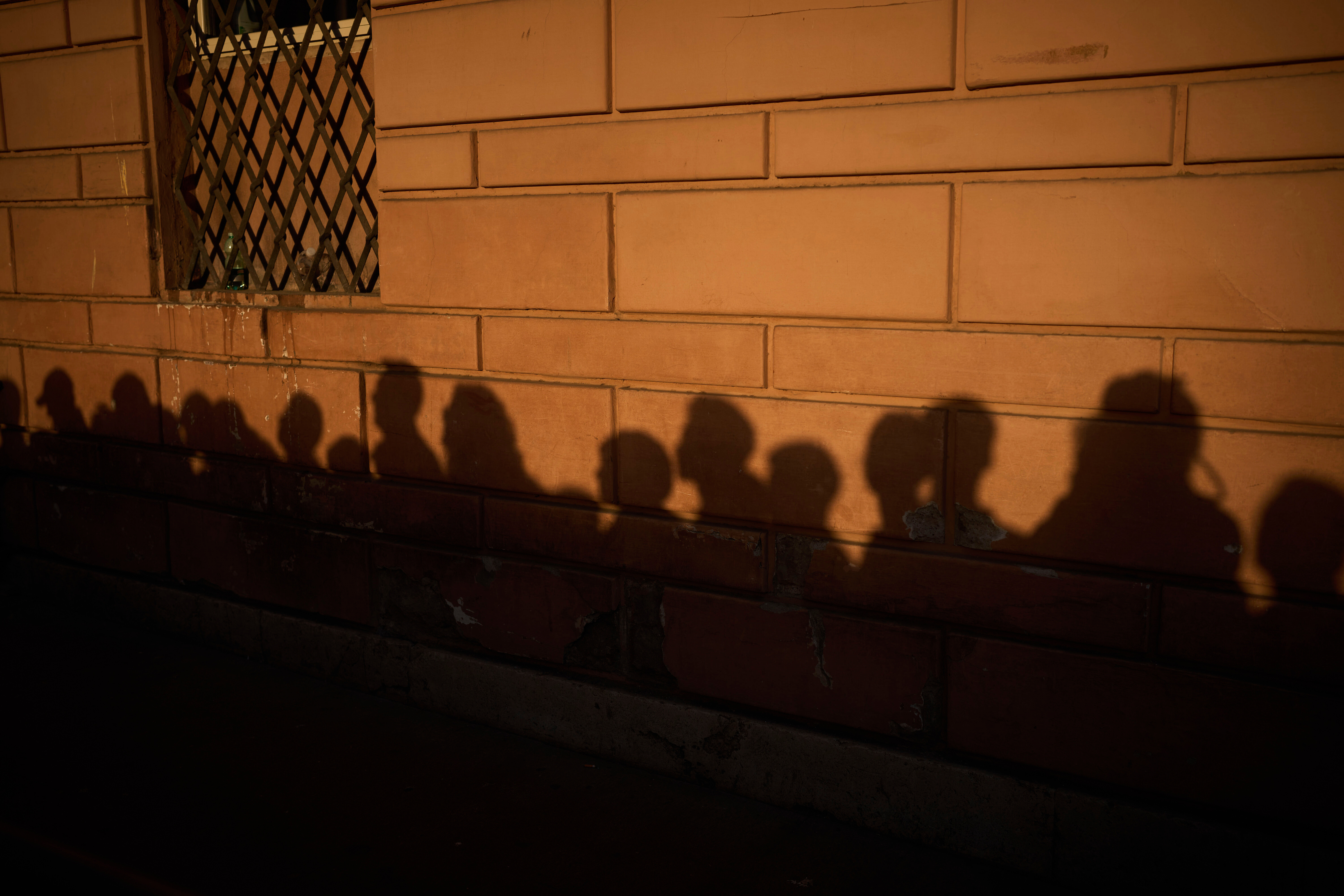 People stand in line as they wait to enter St. Peter's Basilica to pay their respects to Pope Francis lying in state, at the Vatican, Friday, April 25, 2025. (AP Photo/Emilio Morenatti)