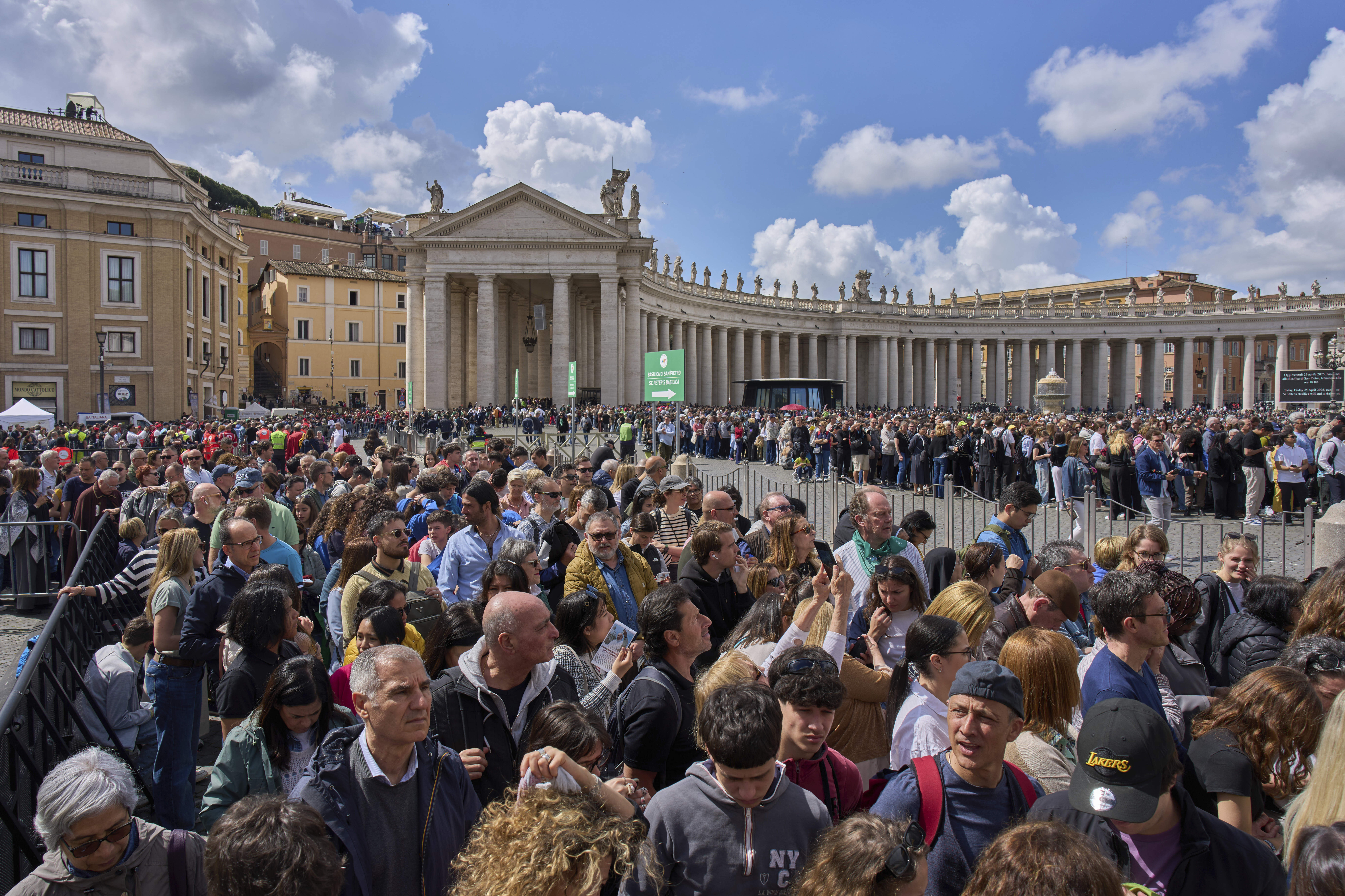 People wait in line to enter St. Peter's Basilica where Pope Francis is lying in state, at the Vatican, Friday, April 25, 2025. (AP Photo/Bernat Armangue)