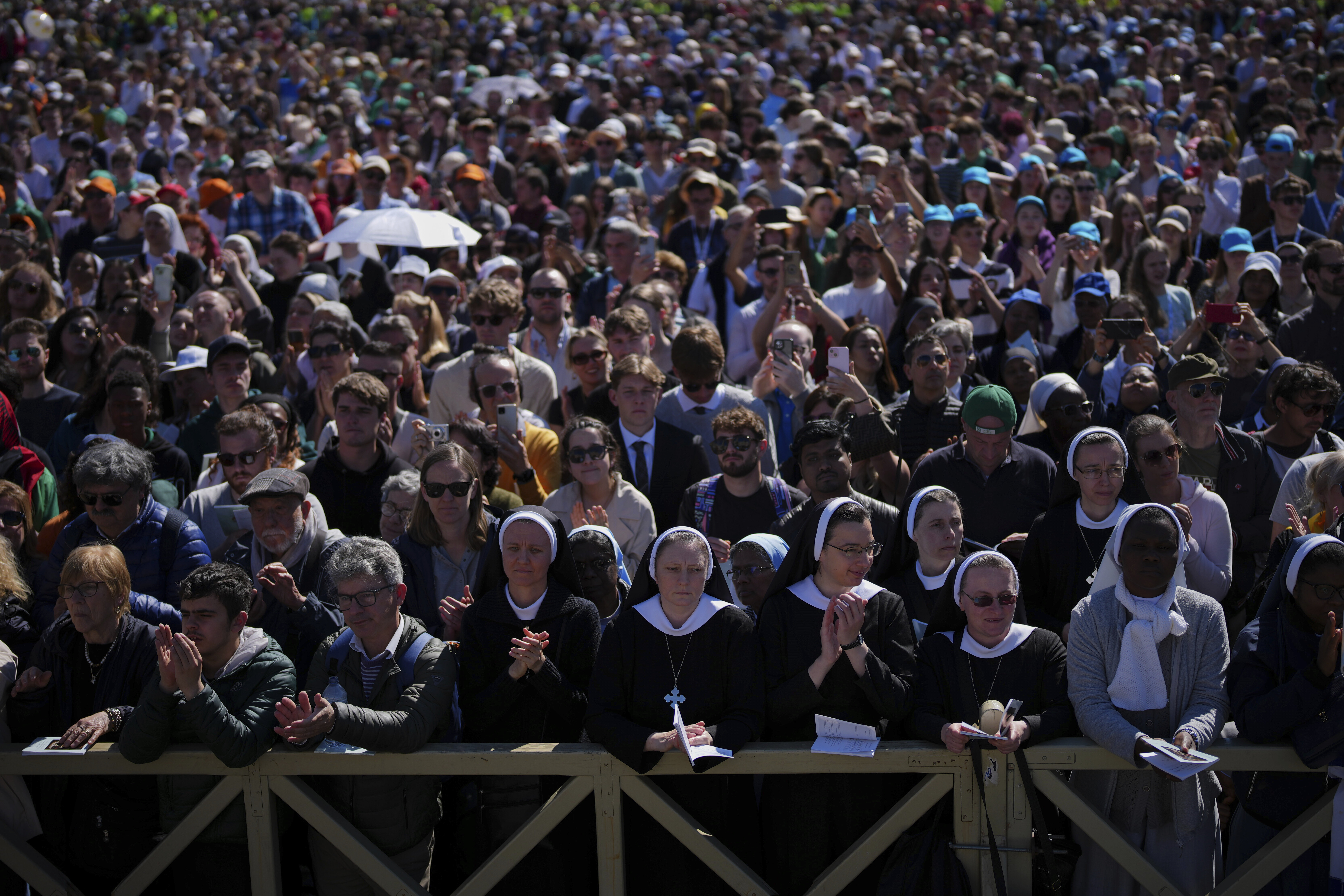 Nuns and faithful listen to mass during the funeral of Pope Francis in St. Peter's Square at the Vatican, Saturday, April 26, 2025. (AP Photo/Emilio Morenatti)