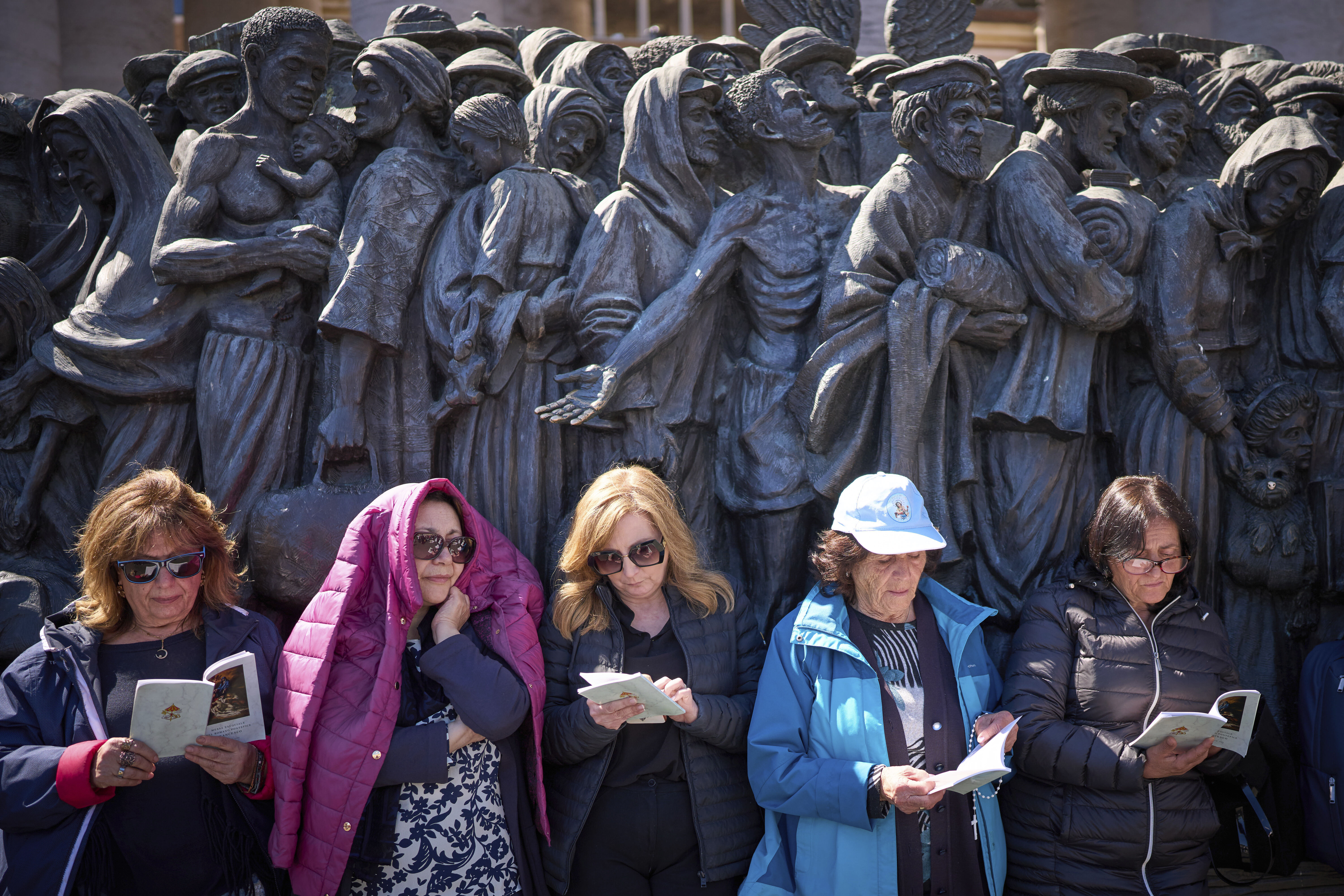 Faithful listen to mass during the funeral of Pope Francis in St. Peter's Square at the Vatican, Saturday, April 26, 2025. (AP Photo/Emilio Morenatti)