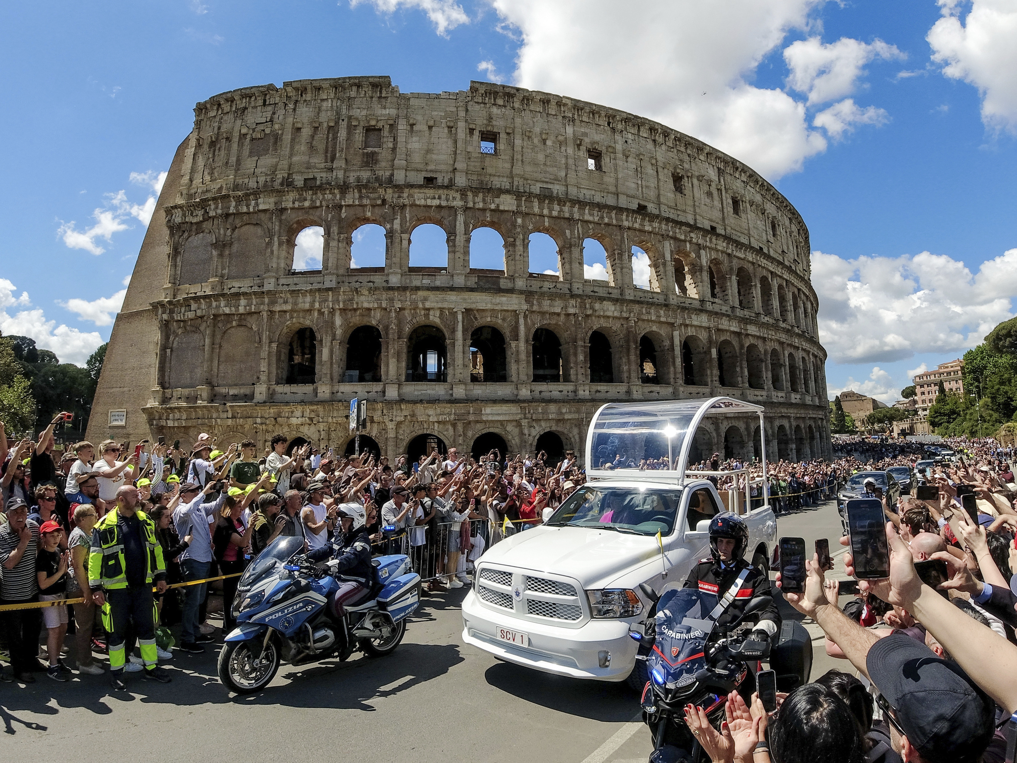 The coffin of Pope Francis is transported in front of the Colosseum on its way to St. Mary Major where he will be buried, Rome, Saturday, April 26, 2025. (Mauro Scrobogna/LaPresse via AP)
