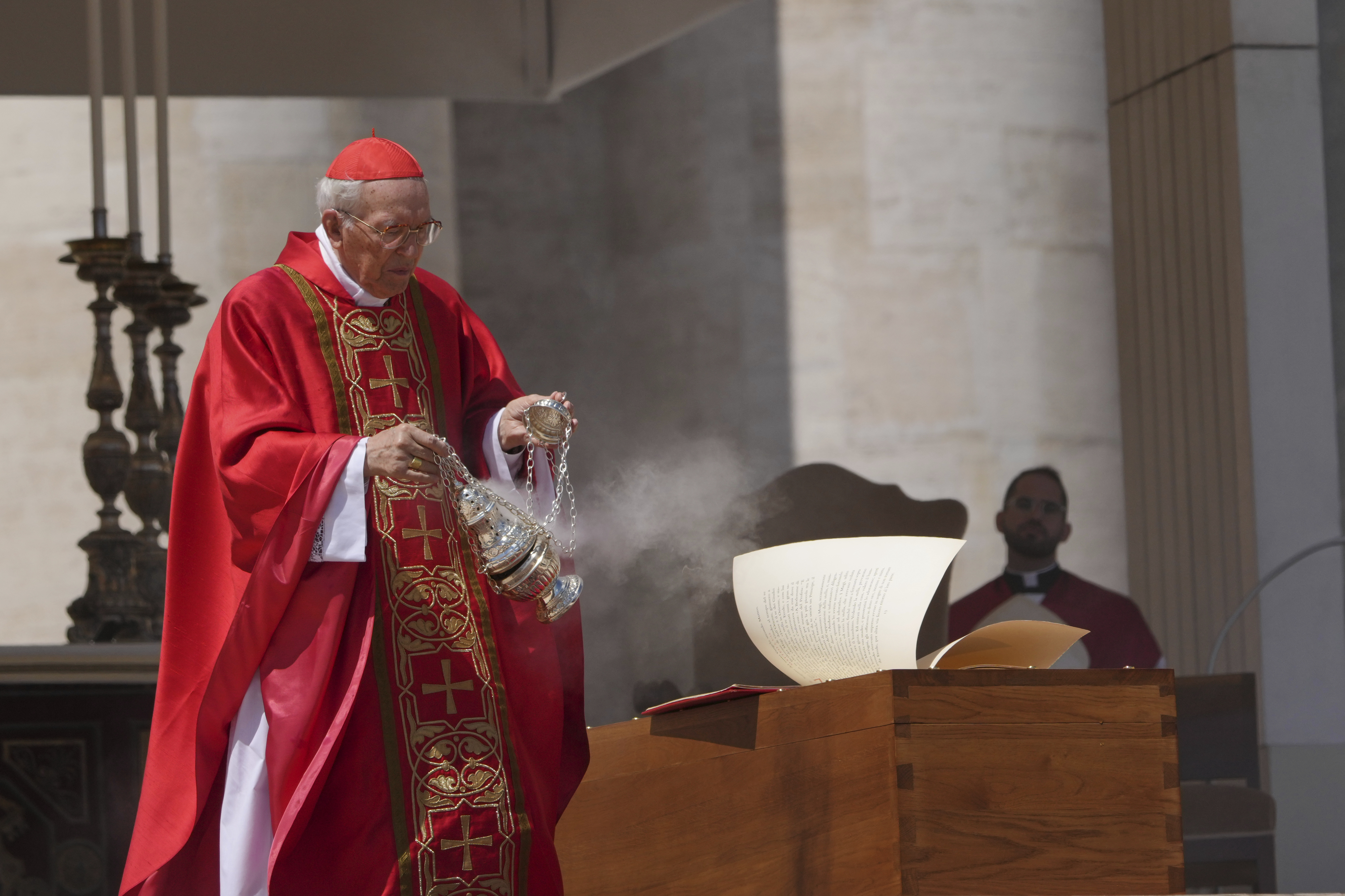 Dean of the College of Cardinals Giovanni Battista Re blesses the coffin during the funeral of Pope Francis in St. Peter's Square at the Vatican, Saturday, April 26, 2025. (AP Photo/Alessandra Tarantino)