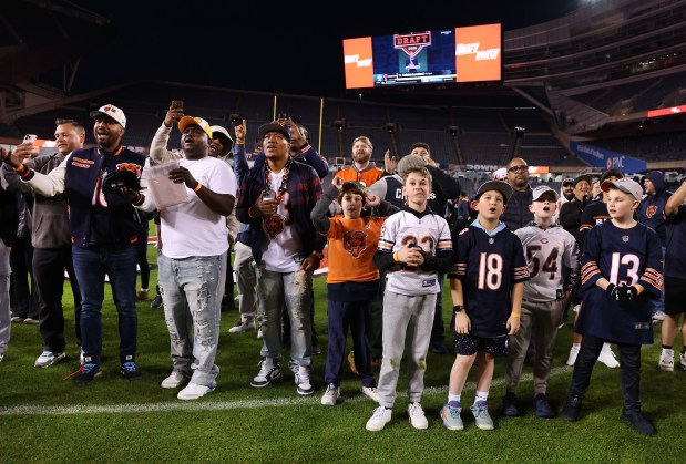 Fans attending a Bears draft party at Soldier Field react after the team chose Michigan tight end Colston Loveland with the No. 10 pick on April 24, 2025. (Chris Sweda/Chicago Tribune)
