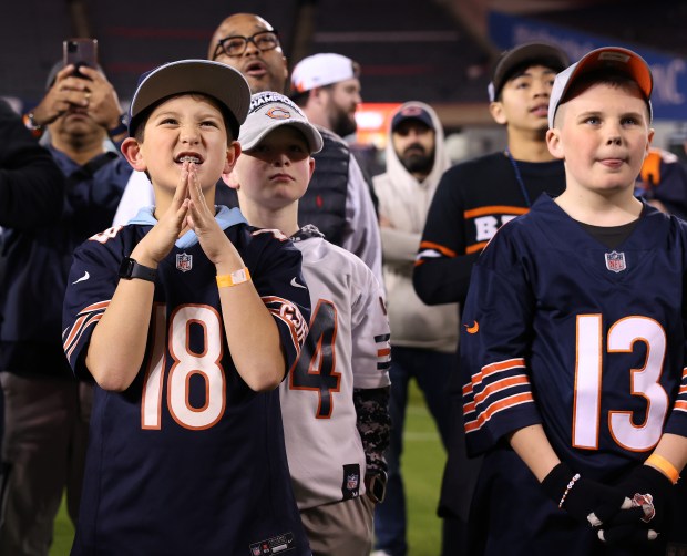 A young fan awaits the Bears' No. 10 pick in the first round as fans attend a draft party at Soldier Field on April 24, 2025. The Bears selected Michigan tight end Colston Loveland with the pick. (Chris Sweda/Chicago Tribune)
