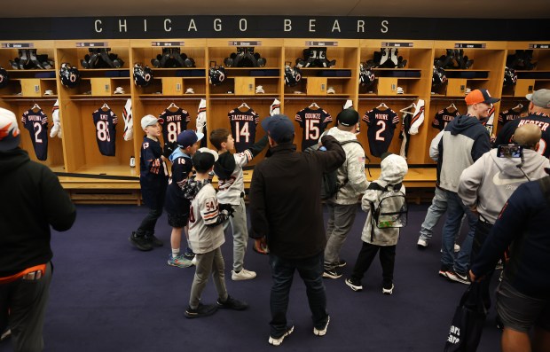 Fans tour the Bears locker room while attending a draft party at Soldier Field on April 24, 2025. (Chris Sweda/Chicago Tribune)