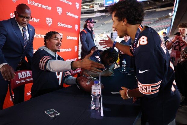Safety Jaquan Brisker says hello to a fan while signing autographs during a Bears draft party at Soldier Field on April 24, 2025. (Chris Sweda/Chicago Tribune)