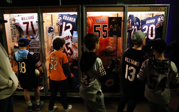 Young fans look at Bears memorabilia while attending a draft party at Soldier Field on April 24, 2025. (Chris Sweda/Chicago Tribune)