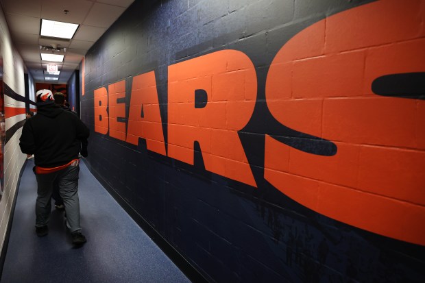 Fans walk through a hallway before touring the locker room while attending a Bears draft party at Soldier Field on April 24, 2025. (Chris Sweda/Chicago Tribune)
