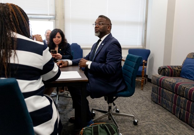 Mayor Brandon Johnson speaks with chief of staff Cristina Pacione-Zayas and budget director Annette Guzman before a meeting with Gov. JB Pritzker at the Stratton Building next door to the Illinois State Capitol on April 30, 2025. (Brian Cassella/Chicago Tribune)