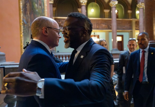 Mayor Brandon Johnson greets Senate President Don Harmon while meeting with lawmakers at the Illinois State Capitol, April 30, 2025, in Springfield. (Brian Cassella/Chicago Tribune)