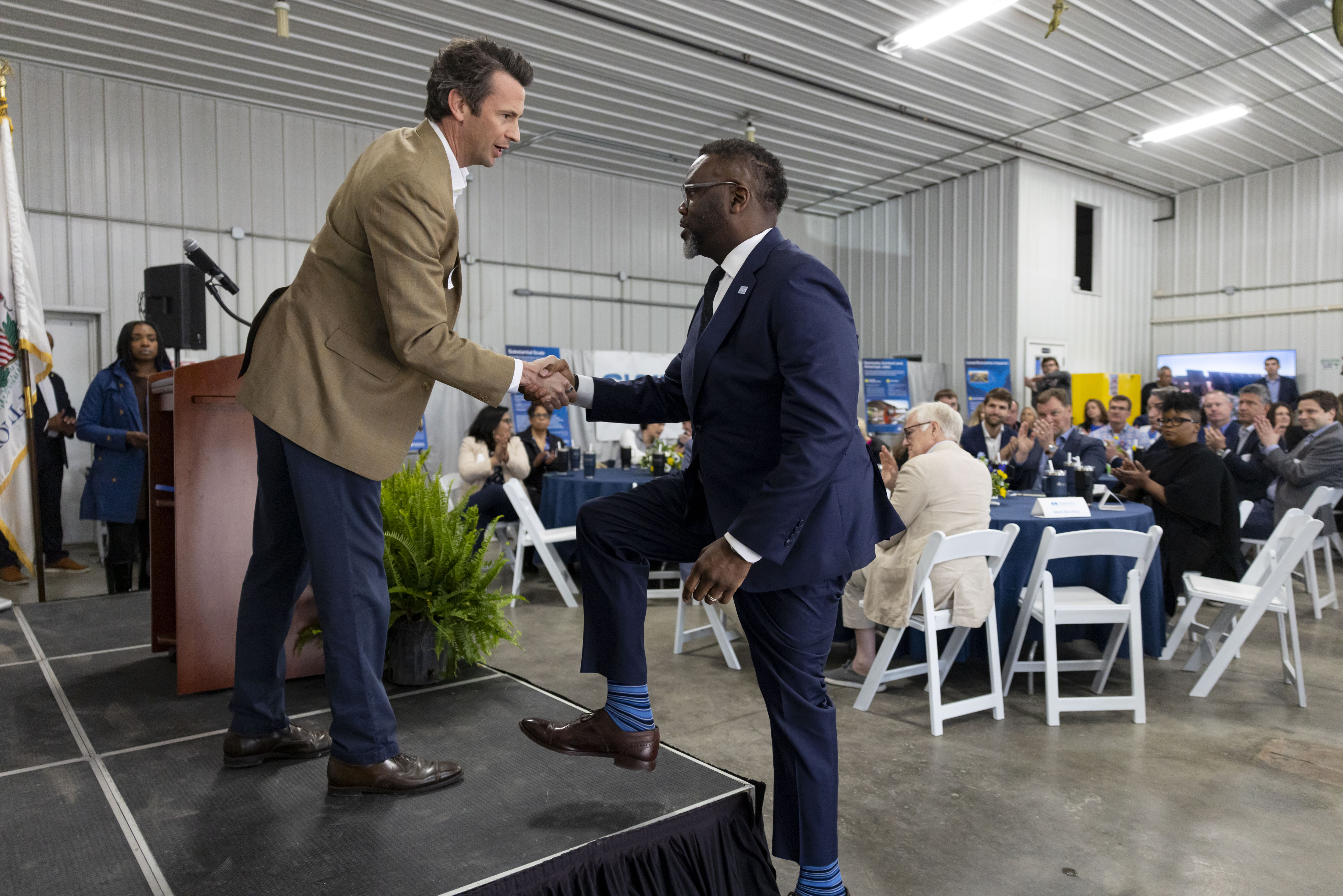 Mayor Brandon Johnson greets Matt Birchby, president of Swift Current Energy, while cutting the ribbon at the Double Black Diamond solar farm Wednesday, April 30, 2025, in Auburn. (Brian Cassella/Chicago Tribune)