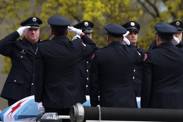 Firefighters salute the casket of fallen Chicago Fire Department Capt. David Meyer before funeral services at St. John Brebeuf Church in Niles, April 29, 2025. (Antonio Perez/Chicago Tribune)