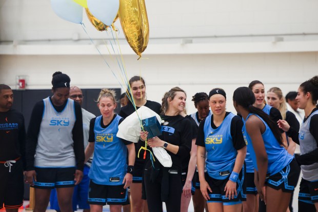 Sky VP of Basketball Operations Ann Crosby holds balloons as players and staff celebrate her 20 years of being an athletic trainer during the first day of training camp Sunday, April 27, 2025, at Sachs Recreation Center in Deerfield. (Eileen T. Meslar/Chicago Tribune)