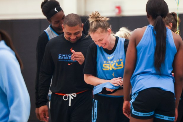 Sky coach Tyler Marsh, left, and guard Courtney Vandersloot laugh at the end of the first day of training camp Sunday, April 27, 2025, at Sachs Recreation Center in Deerfield. (Eileen T. Meslar/Chicago Tribune)