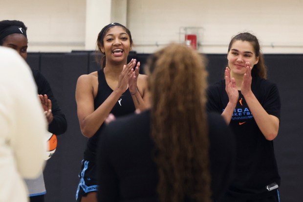 Sky forwards Angel Reese, left, and Maddy Westbeld clap in a huddle at the end of the first day of training camp Sunday, April 27, 2025, at Sachs Recreation Center in Deerfield. (Eileen T. Meslar/Chicago Tribune)