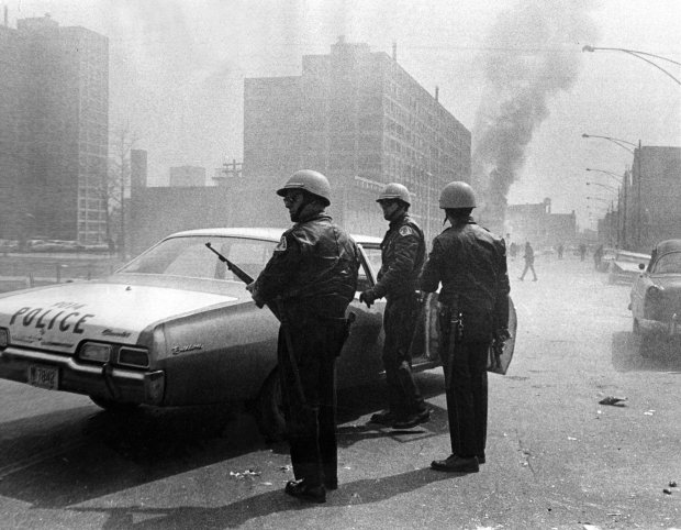 Chicago police got out of a squad car after it was hit by gunfire on Larrabee Street, south of Division Street, during the rioting on April 6, 1968. (Steve Lasker/Chicago American)