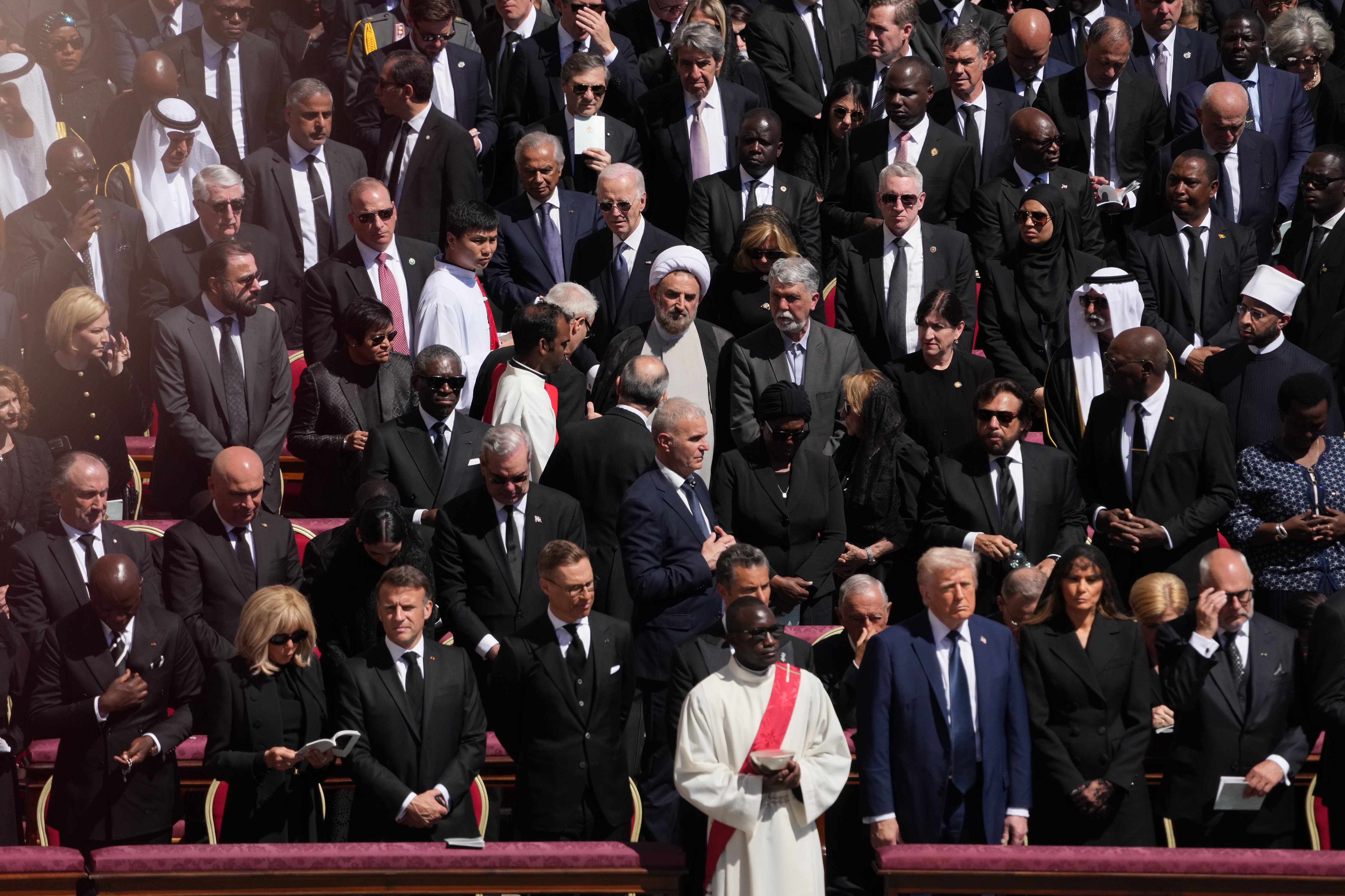 A priest stands in front of the many dignitaries and heads of state attending the funeral of Pope Francis, at St. PeterÕs Square in Vatican City on Saturday, April 26, 2025. (Eric Lee/The New York Times)