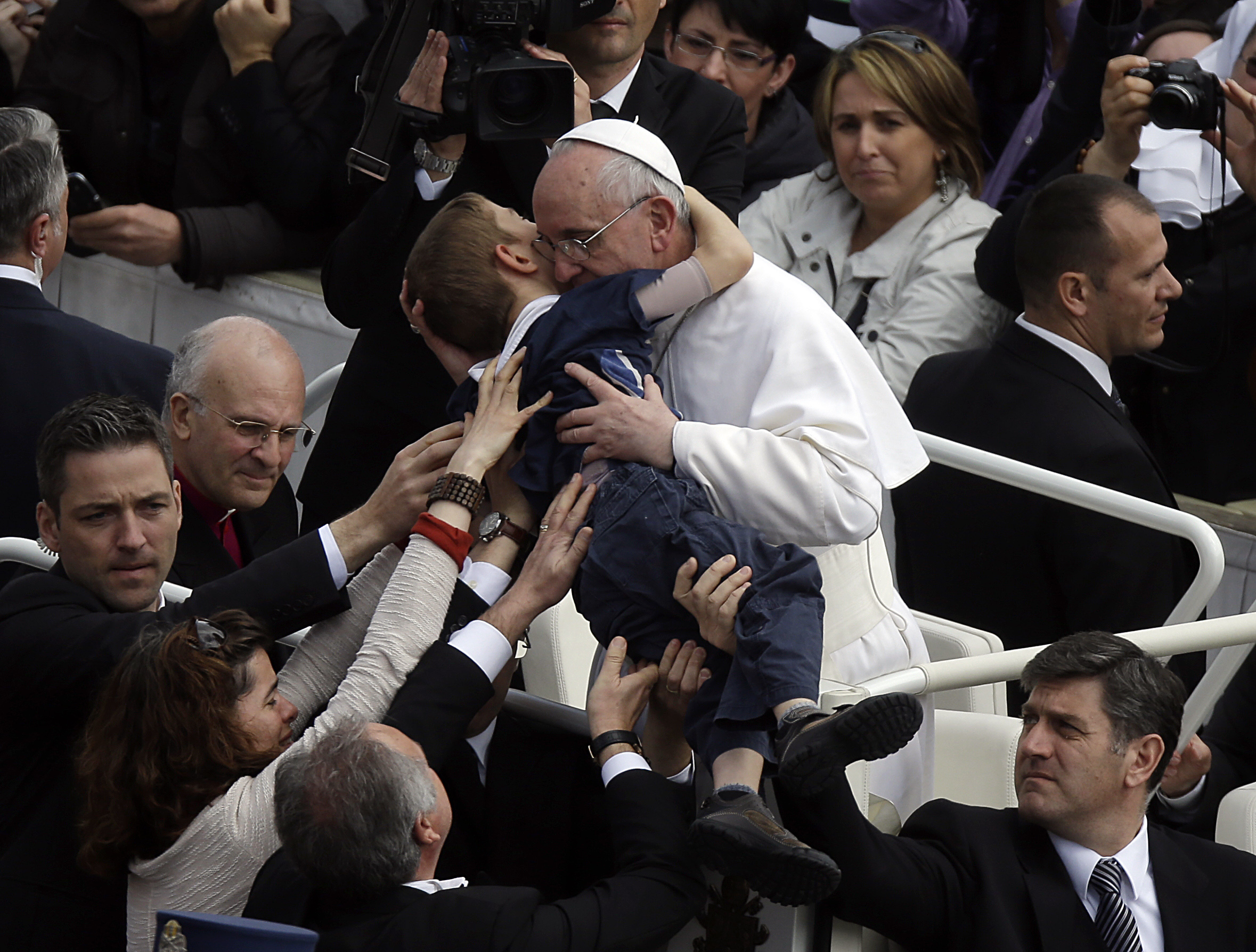 Pope Francis hugs 8-year-old Dominic Gondreau, who has cerebral palsy, after celebrating his first Easter Mass in St. Peter's Square at the Vatican on March 31, 2013. (Gregorio Borgia/AP)