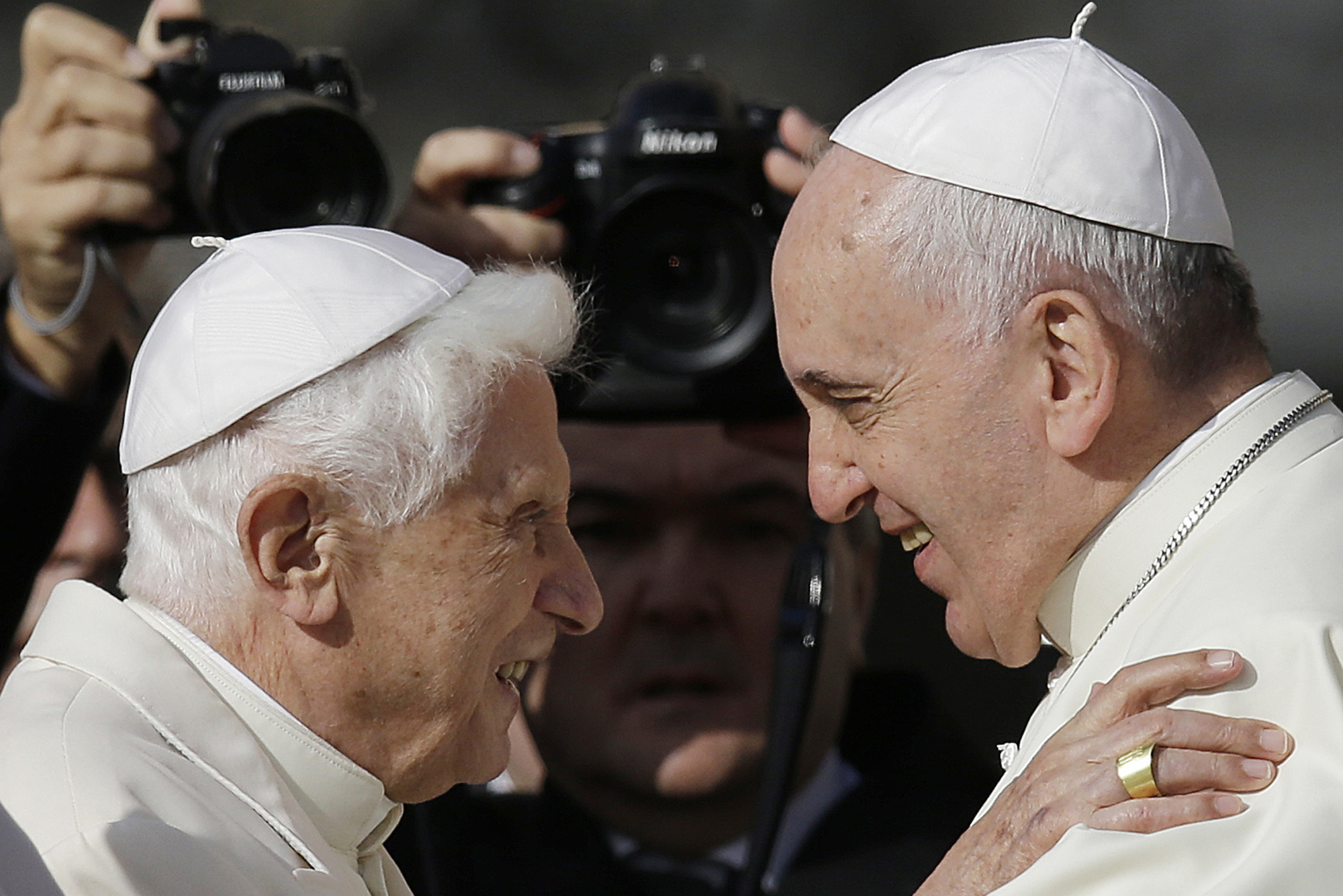 Pope Francis, right, hugs Emeritus Pope Benedict XVI prior to the start of a meeting with elderly faithful in St. Peter's Square at the Vatican on Sept. 28, 2014. (Gregorio Borgia/AP)