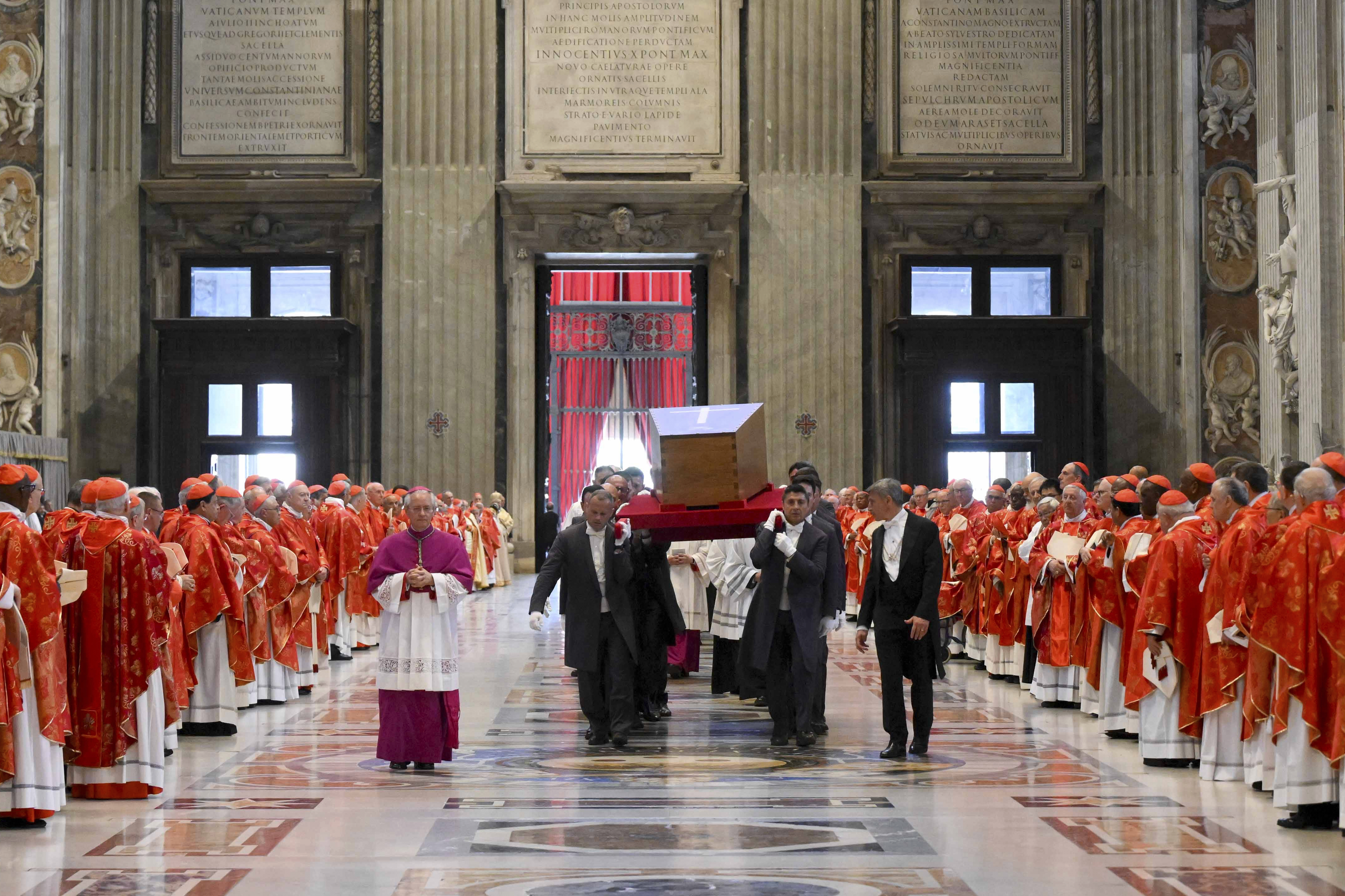 The coffin containing the body of late Pope Francis is brought inside St. Peter's Basilica at the end of his solemn funeral in St. Peter's Square at the Vatican Saturday, April 26, 2025. (Vatican Media via AP)
