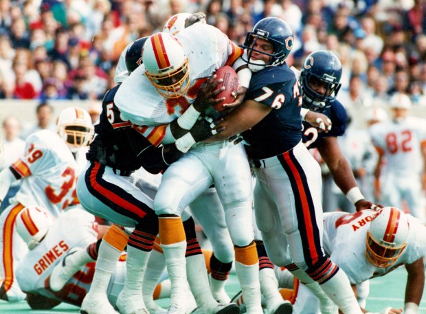 The Bucs' James Wilder is stopped by the Bears' Steve McMichael (76) and Wilber Marshall during a game in October 1987. (Ed Wagner Jr./Chicago Tribune)